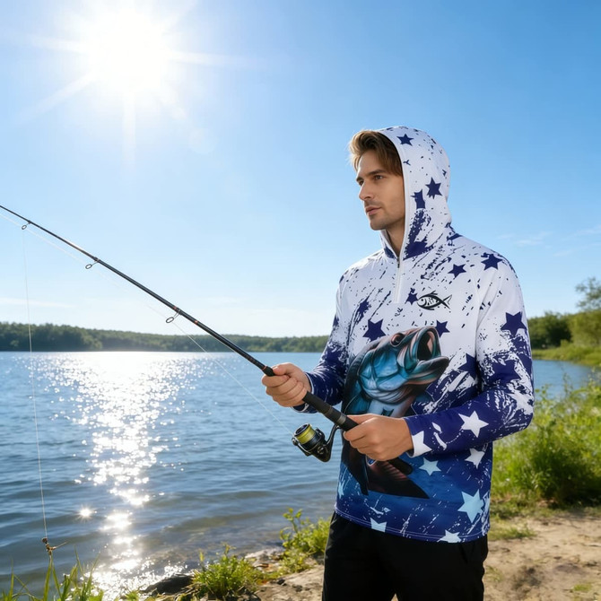 A white and blue men's fishing hood shirt with star patterns and a fish graphic, worn by a man near water.