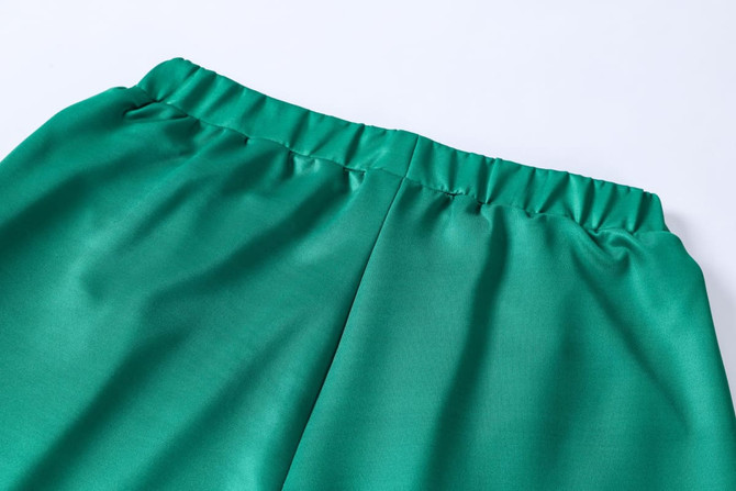 Unisex adult shorts in a vibrant green colour, made from 100% polyester with an elastic waistband.