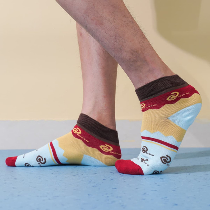 Ankle socks featuring a custom pattern in blue, yellow, red, and brown, with branding visible on the design.