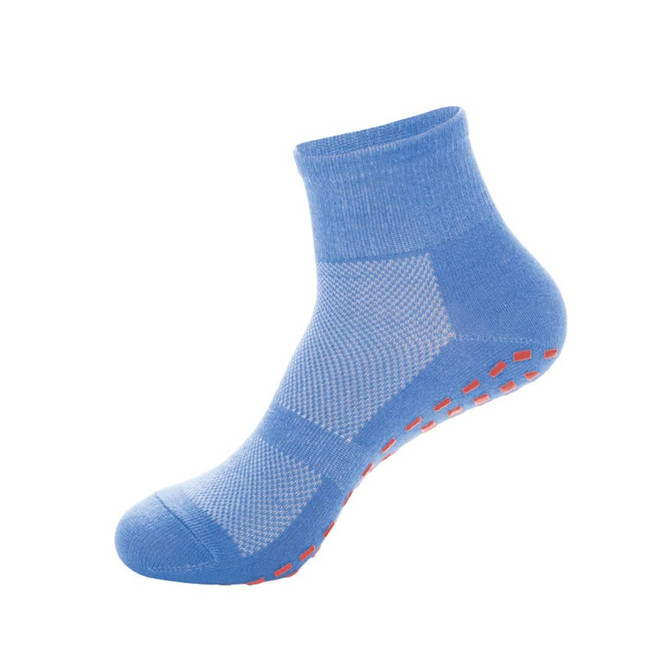 A pair of blue kids' gripper socks featuring a textured design and red non-slip dots on the sole.