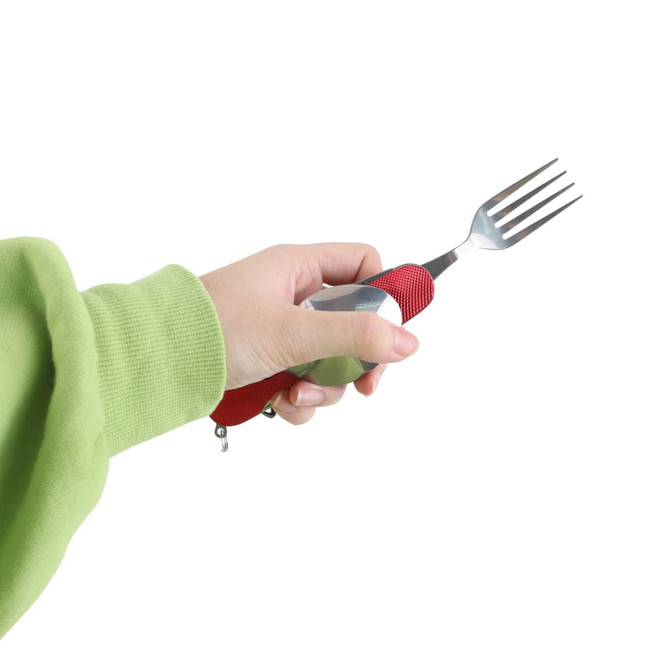 A hand holds a red and silver camping cutlery tool featuring a fork, with a textured grip.