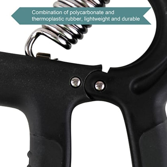 A close-up of a black adjustable hand grip made from polycarbonate and thermoplastic rubber with a spring mechanism.