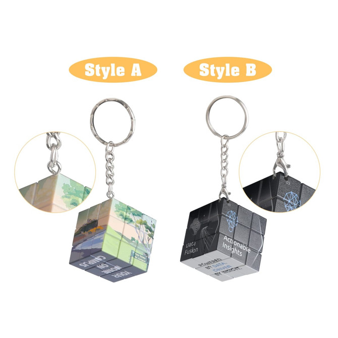 A pair of colourful 3x3 puzzle cube keyrings in two different designs, attached to metal keychains.