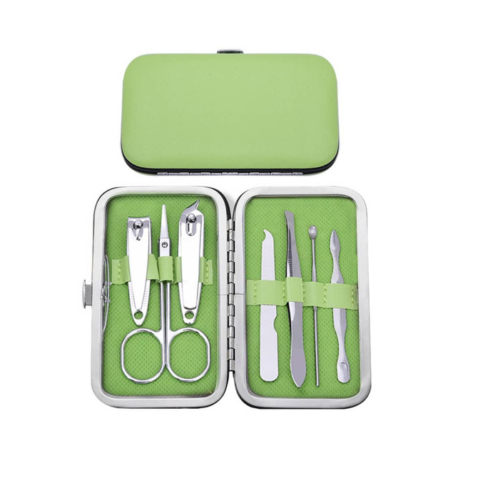 A stylish green manicure set in a metal case, containing scissors, clippers, and various nail tools.