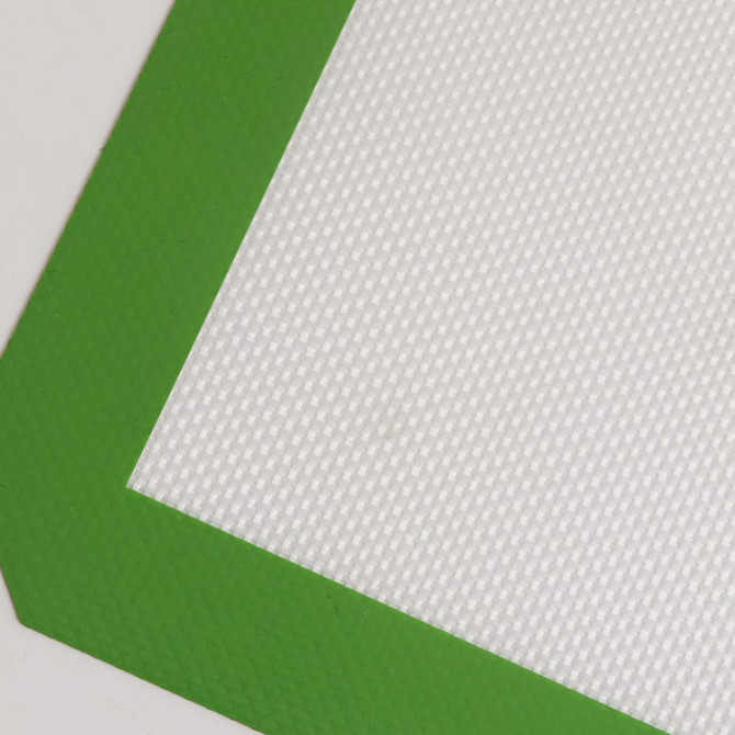 A silicone baking mat featuring a textured white surface and a green border.