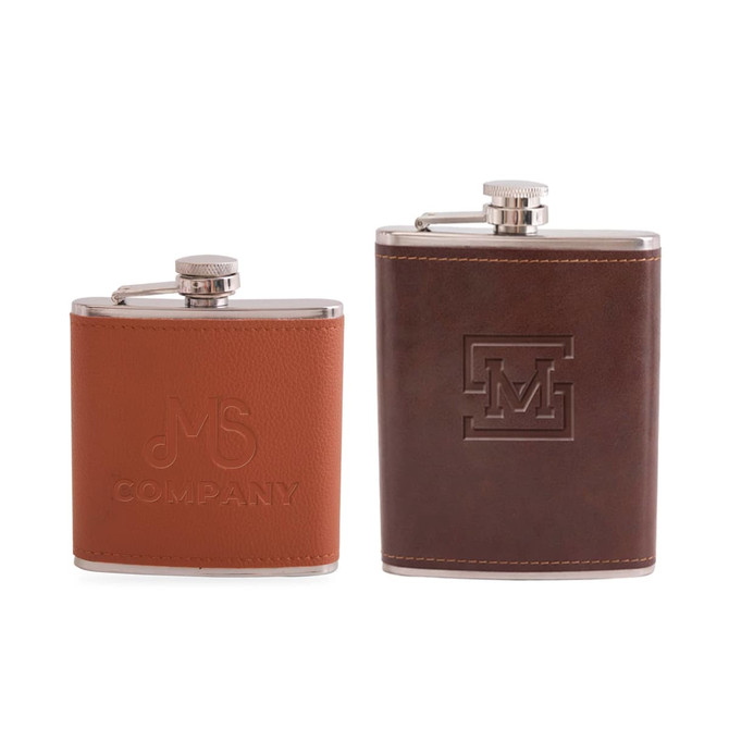 A drink bottle featuring two classic hip flasks in brown leather and stainless steel, each with distinct engravings and branding.
