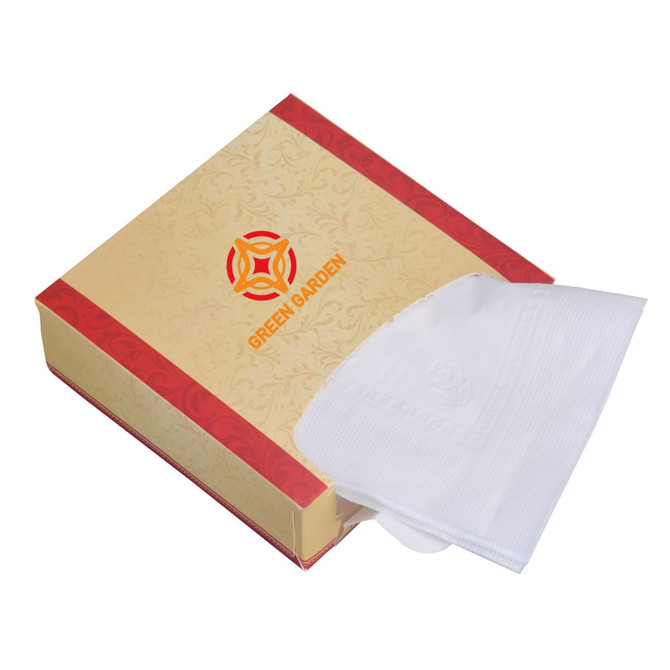 A decorative mini tissue box in a cream and red design, containing white tissues and featuring a logo.