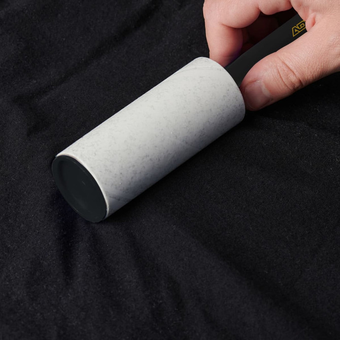 A lint remover with a grey handle, designed for removing lint and debris from fabric surfaces.