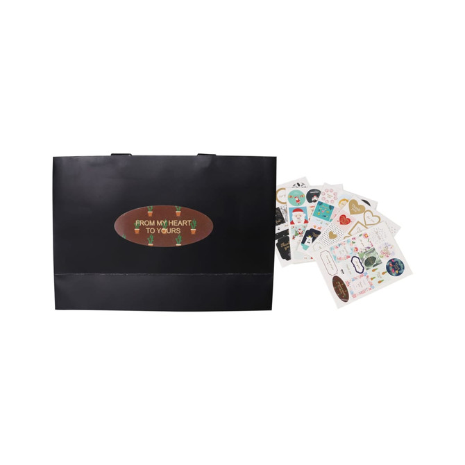 A medium black paper bag with flat handles, accompanied by assorted decorative stickers.
