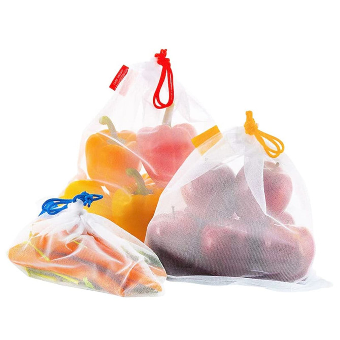 A set of three white mesh produce bags, containing colourful vegetables and fruits, featuring various coloured drawstrings.