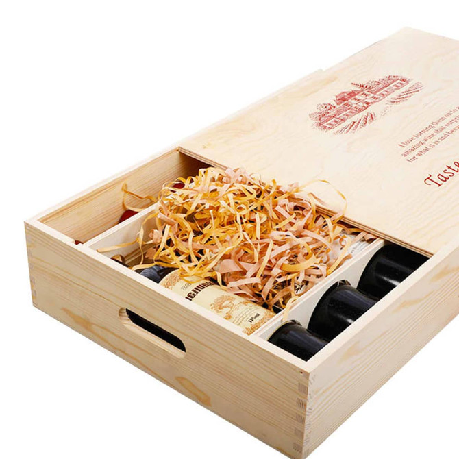 A wooden gift box in natural wood finish, holding six wine bottles with decorative packing straw inside.