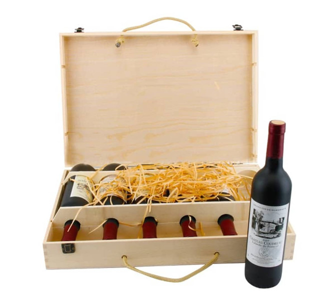 A vintage wooden wine box containing six drink bottles and one displayed bottle, with straw filling. The box is light-coloured.