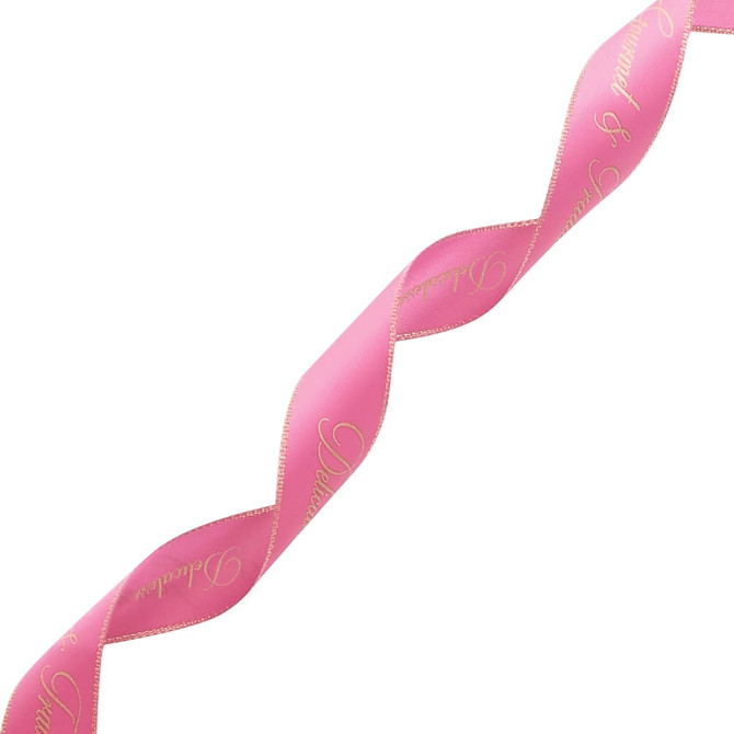 A pink ribbon with gold edges and elegant writing, featuring a branding logo.