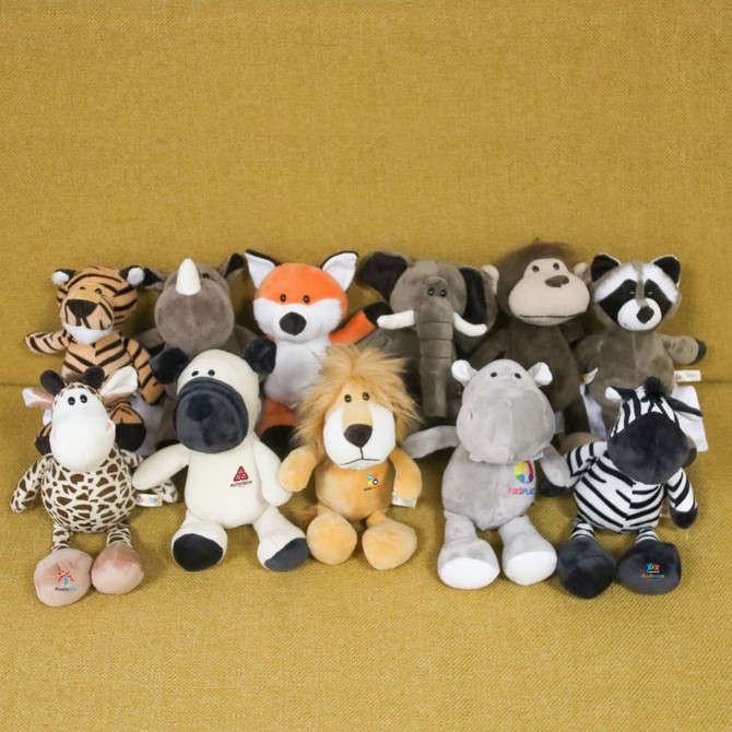 A collection of various plush toys including a zebra, giraffe, lion, elephant, fox, and other animals, all in soft, vibrant colours.