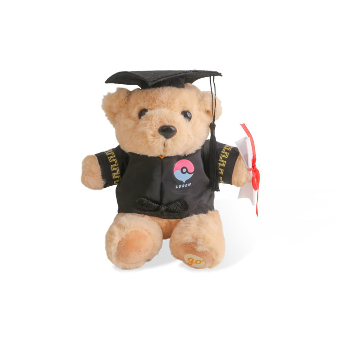 A tan plush bear wearing a graduation cap and gown, holding a diploma. The bear has a logo on its gown.