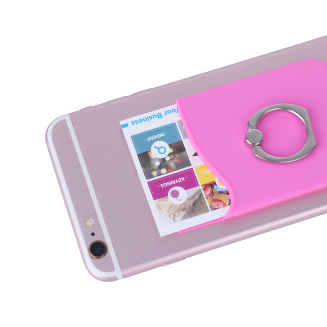 A pink smart wallet with a ring, attached to a smartphone, holding a card. The phone is white and silver.