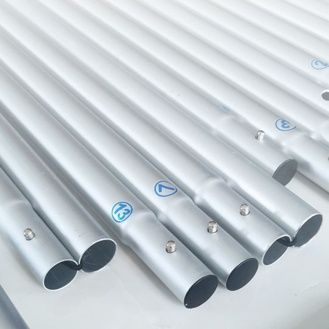 A set of silver metal poles arranged on a flat surface, featuring small blue markings.