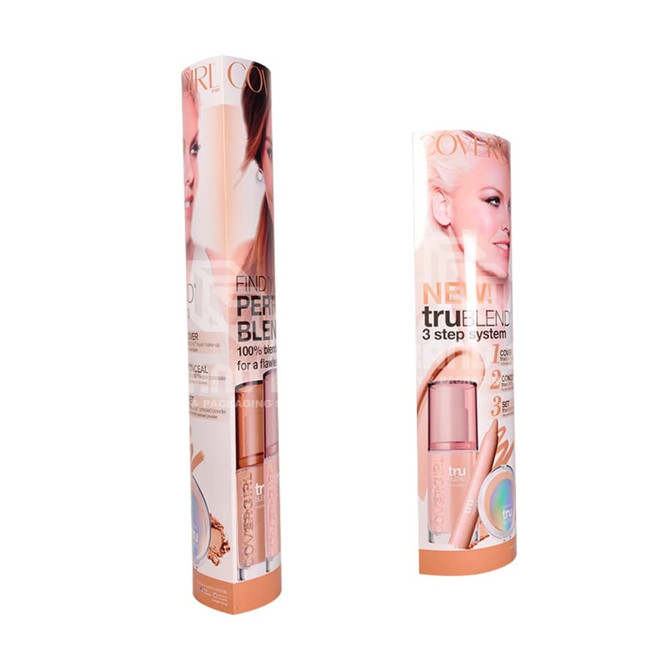 Two cylindrical cardboard displays featuring a cosmetics product, primarily in shades of peach and beige, with a branding logo.