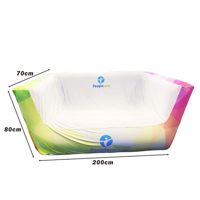 An inflatable two-seat sofa in a gradient of colours, featuring a white interior and a logo on the side.
