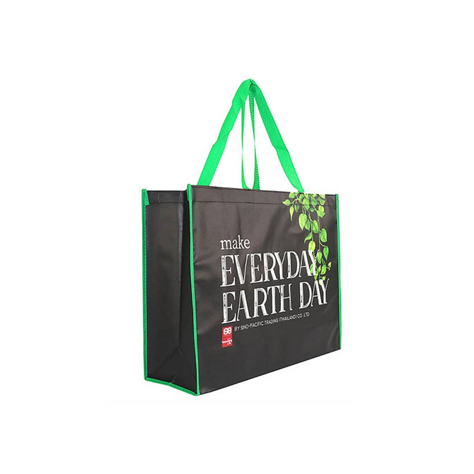 A black laminated non-woven trade show bag with green accents and a leafy design. Features sturdy handles and logo branding.