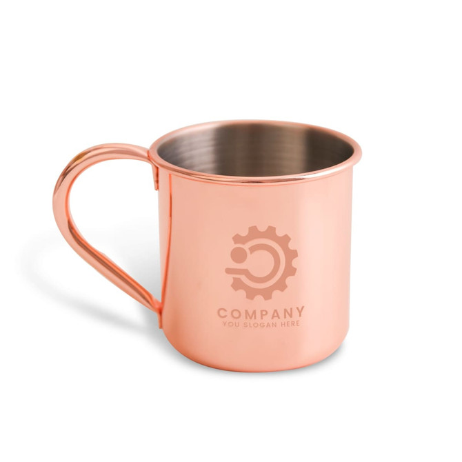 A copper mug with a polished finish and a handle, featuring an engraved logo on the front.