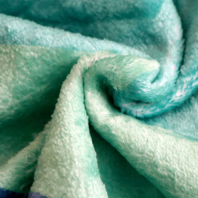 A soft, mint green flannel blanket with a textured, plush surface. The blanket features a subtle pattern.