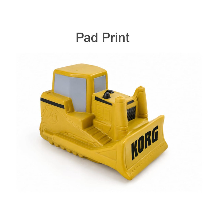 A yellow bulldozer-shaped stress reliever with a dark grey cabin and a logo on the side.