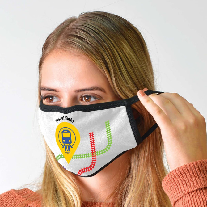 A cotton face mask in white with black edges, featuring a colorful train graphic and logo.