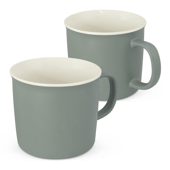 A drink mug set in muted green with cream interior, featuring a simple handle and a smooth finish.