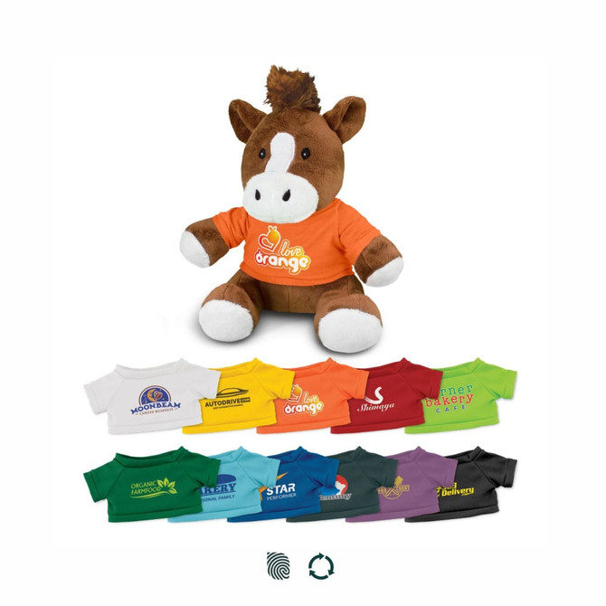 A plush horse toy wearing an orange shirt, surrounded by various smaller T-shirts in different colours.