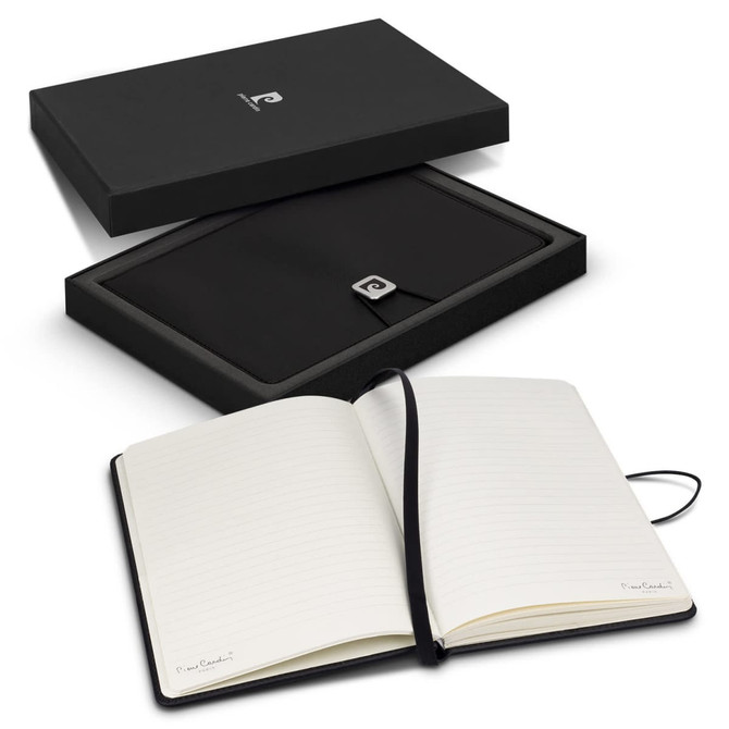 A black gift box containing an open notebook with lined pages and a logo on the cover.