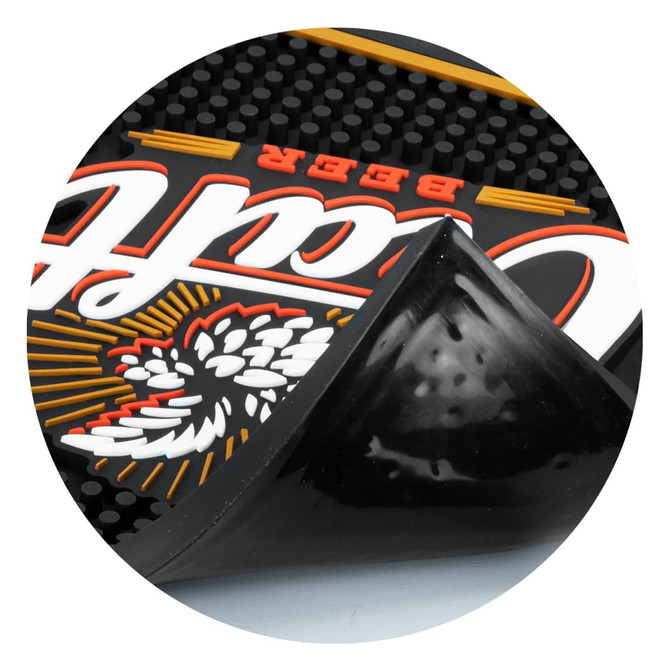 A large black PVC bar runner with textured surface and a logo, partially lifted at the corner.