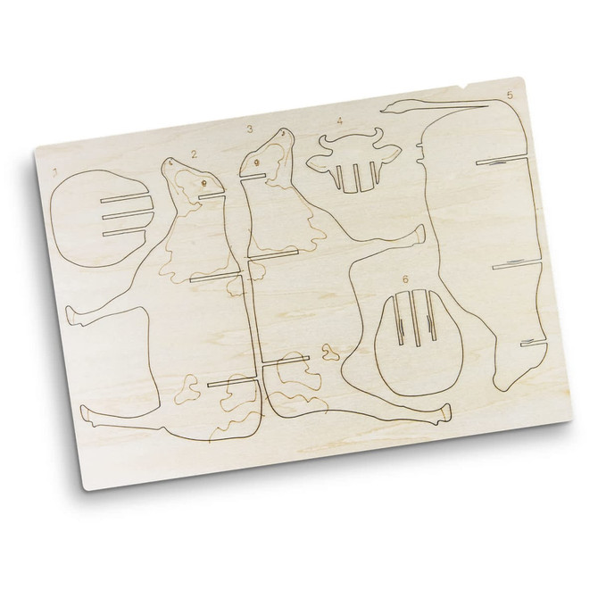 A wooden model kit featuring a cow design, with engraved parts for assembly on a light-coloured wood base.
