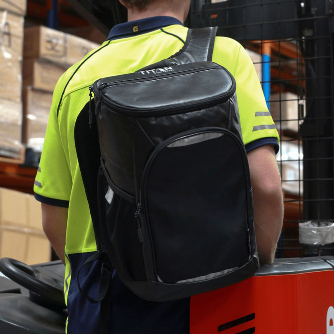 A black cooler backpack with a logo, worn by a person, featuring padded straps for carrying.