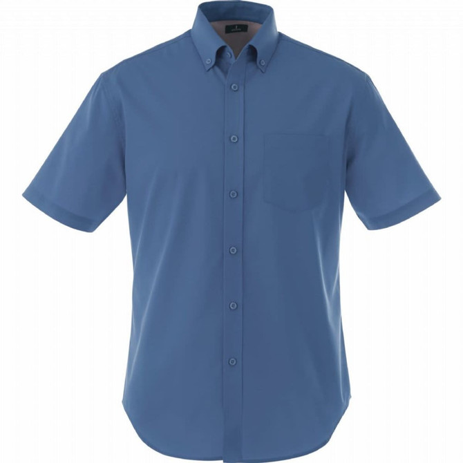 A short sleeve button-up shirt in blue with a chest pocket and a logo on the label.