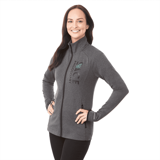 A woman wearing a grey Asgard Eco Knit Jacket with a fitted design and zippered pockets, featuring a logo.