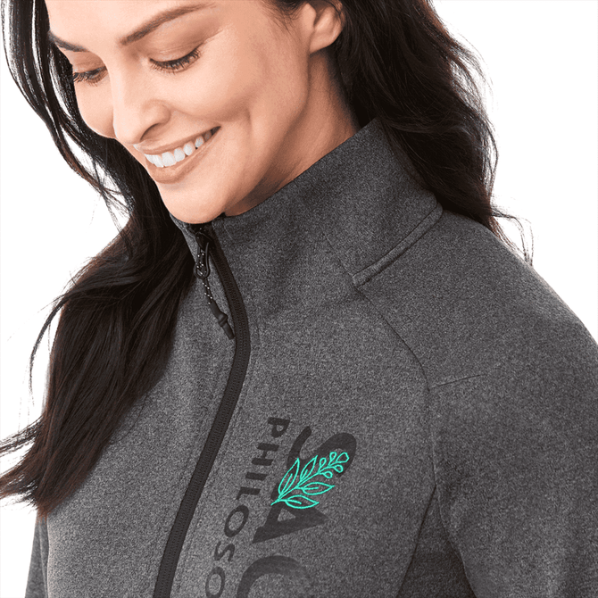 A grey eco knit jacket designed for women, featuring a zipper and a logo with a leaf motif.