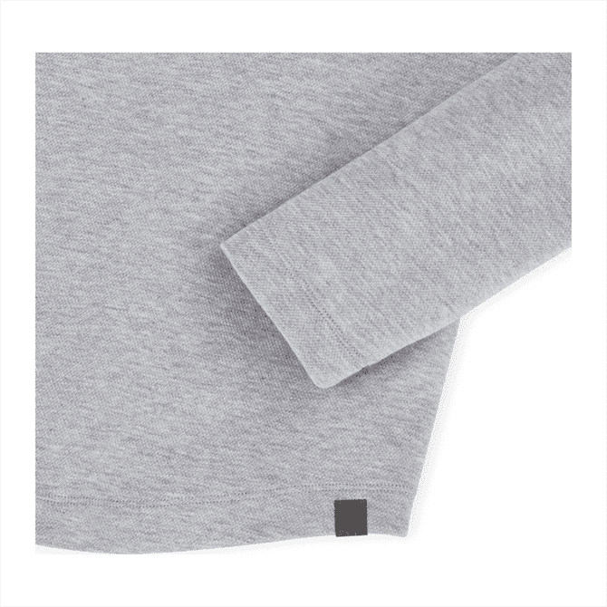 A light grey quarter zip jacket with a subtle branding tag at the hem and a soft knit texture.