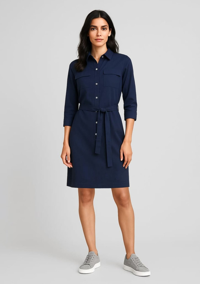 A navy blue women's dress with a button-up front, a tie belt at the waist, and two chest pockets.