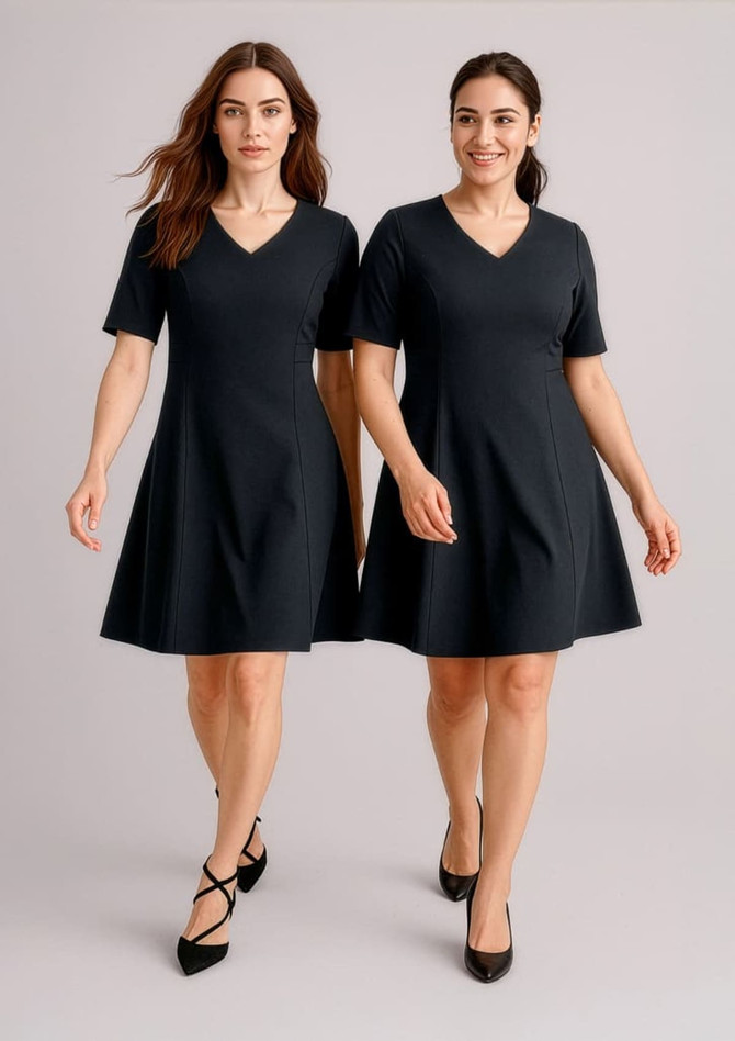 Two women wearing black extended short sleeve dresses, featuring a V-neck and a flared skirt. The dresses have a simple design.