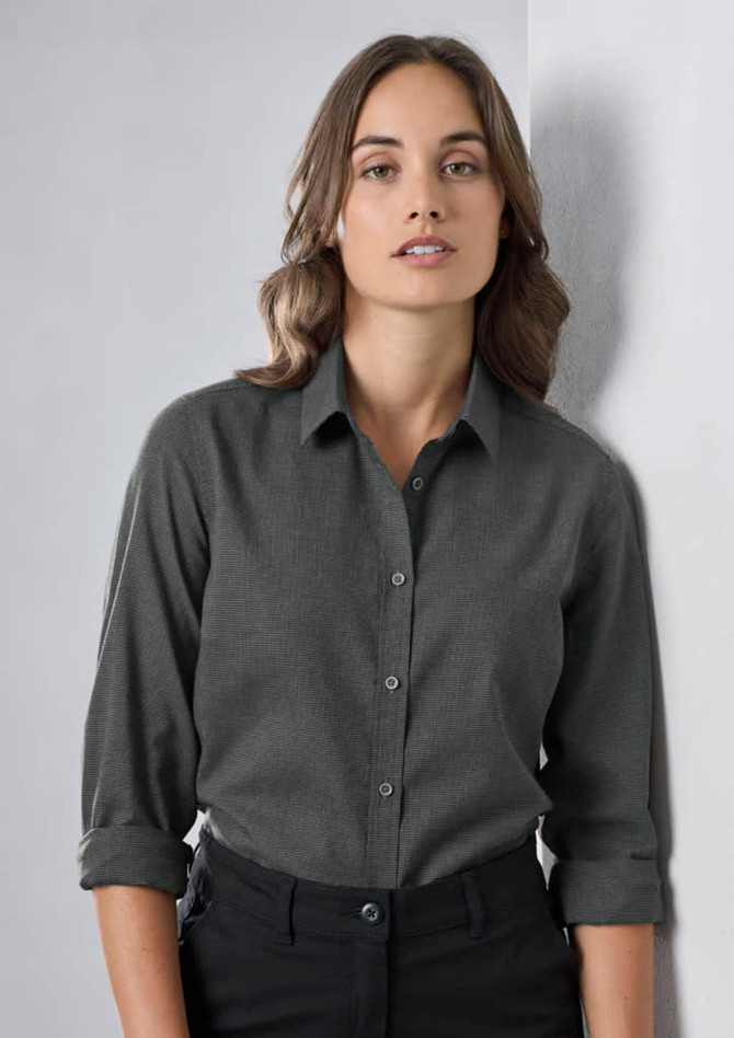A women's long sleeve button-up shirt in dark grey, featuring a collar and rolled-up sleeves. The shirt has a logo.