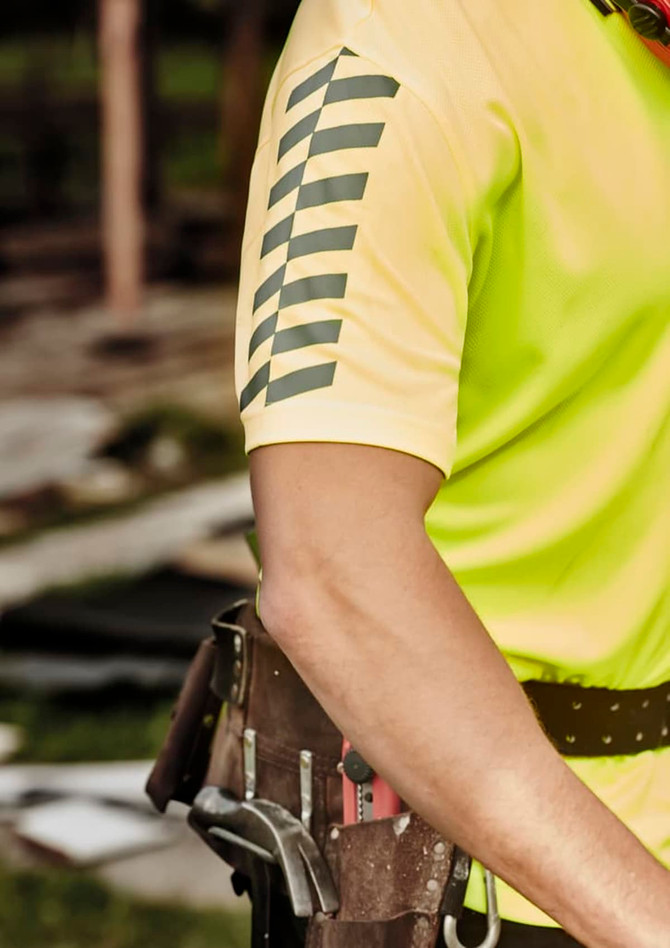 A high visibility short sleeve polo shirt in bright yellow with reflective stripes on the sleeves. It has a logo.