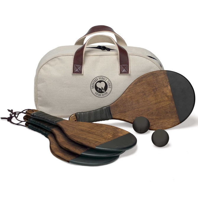 A paddle tennis set featuring wooden paddles, two balls, and a cream-coloured carrying bag with a logo.