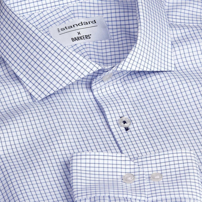 A blue and white check button-up shirt with a collar and a branding label inside.