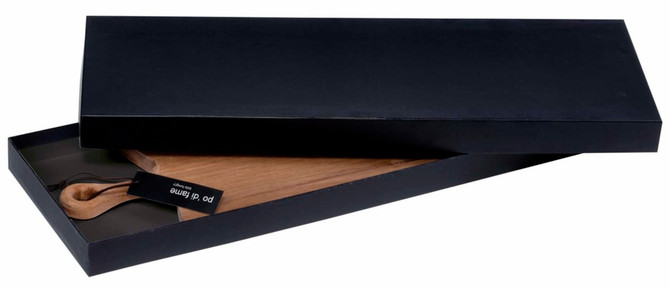A wooden serving board in a black gift box, featuring a handle and branded tag.