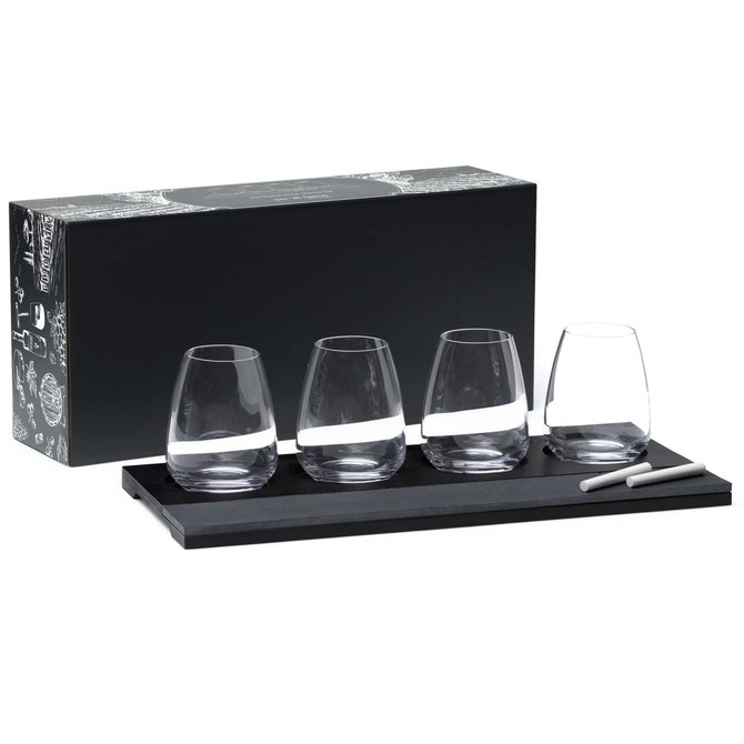 A wine tasting set featuring four clear glasses on a black wooden tray, accompanied by a chalk pen and packaging.