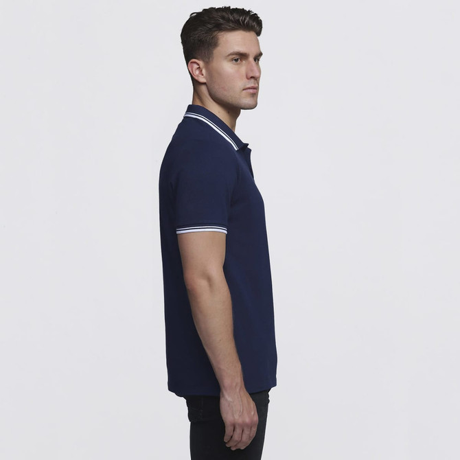 A navy blue polo shirt with contrasting white stripes on the collar and sleeves, featuring a logo.