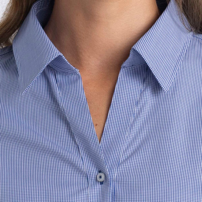 A women's button-up shirt in blue and white check pattern, featuring a collar and button closure. It has a logo.