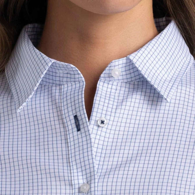A close-up of a women's button-up shirt featuring a blue and white check pattern, with a collar and buttons.