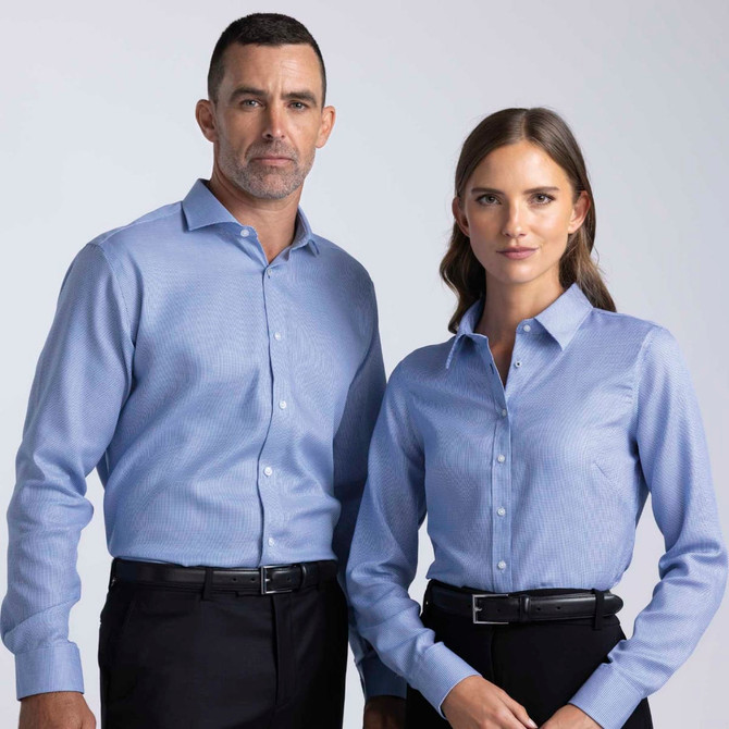 A blue button-up shirt for women, featuring a collar and a fitted design, displayed alongside a matching men's shirt.
